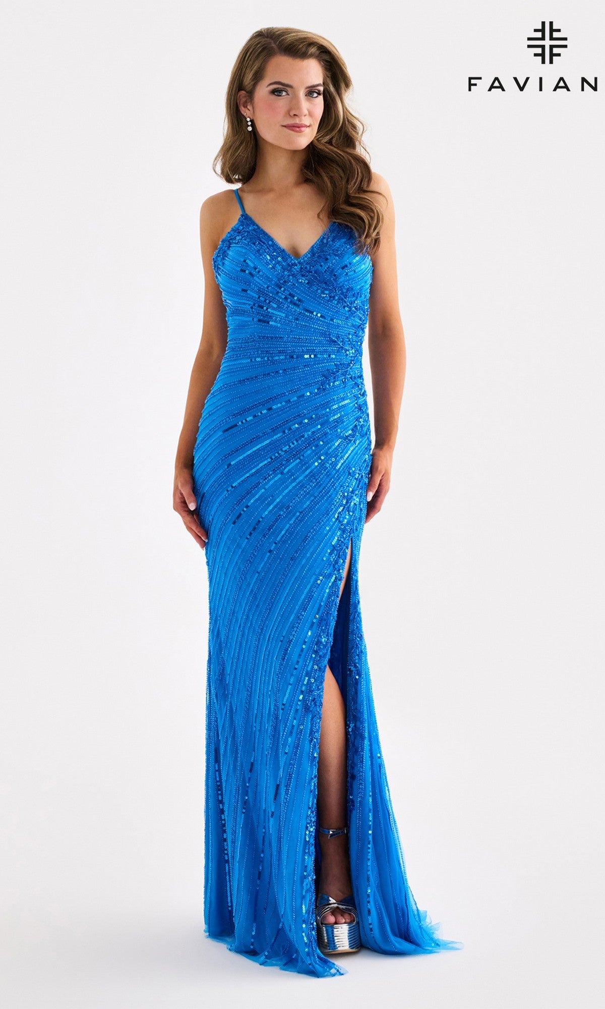 A woman wearing the Faviana 11462 long prom dress, featuring a vibrant blue color, v-neckline, thin straps, sequin embellishments, and a thigh-high slit—perfect as a stunning sequin prom gown.